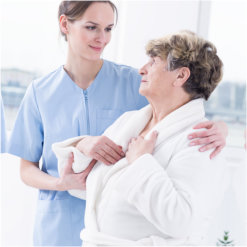 caregiver hugging an elder woman
