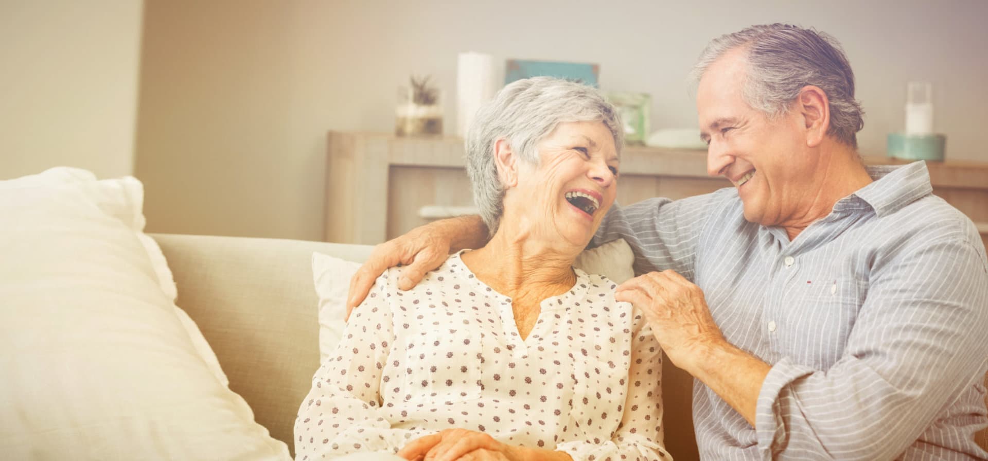 elderly couple smiling at each other