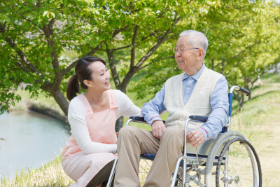 caregiver and senior smile in the field
